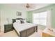 Cozy bedroom with a queen bed, matching nightstands, and soft green walls at 5377 Quarry Rock Rd, Lakeland, FL 33809