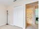 Carpeted room featuring double door closet and a doorway leading to a bathroom at 5377 Quarry Rock Rd, Lakeland, FL 33809