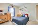 Bright bedroom featuring train decals, ceiling fan, and large windows with blue curtains at 5377 Quarry Rock Rd, Lakeland, FL 33809