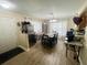 Bright dining area with a table set for six, stainless steel refrigerator and wood flooring at 5377 Quarry Rock Rd, Lakeland, FL 33809