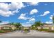 Gated community entrance with stone signage and beautiful landscaping under a blue sky at 5377 Quarry Rock Rd, Lakeland, FL 33809