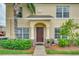 Inviting home entrance with a well-manicured garden, lush green shrubbery and a beautiful brown front door at 5377 Quarry Rock Rd, Lakeland, FL 33809