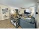 Cozy living room featuring a blue sectional sofa, modern decor, and wood-look flooring at 5377 Quarry Rock Rd, Lakeland, FL 33809