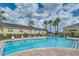 Community pool with palm trees and lounge chairs surrounding the clear blue water at 5377 Quarry Rock Rd, Lakeland, FL 33809