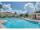 Community pool area with clear water and palm trees in a sunny outdoor setting at 5377 Quarry Rock Rd, Lakeland, FL 33809