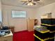 Cluttered bedroom with a stack of storage containers, dresser, and red carpet at 5422 Oakway Dr, Lakeland, FL 33805