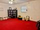 Bedroom featuring vibrant red carpet and natural light through the window at 5422 Oakway Dr, Lakeland, FL 33805