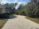 Long concrete driveway with a side view of the house at 5422 Oakway Dr, Lakeland, FL 33805