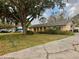 Charming ranch style home with a well-manicured front yard and mature trees at 5422 Oakway Dr, Lakeland, FL 33805