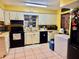 Functional kitchen features classic appliances and tile flooring, ready for your personal touch at 5422 Oakway Dr, Lakeland, FL 33805