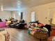 Living room showing neutral walls, wood-look flooring, and abundant natural light at 5422 Oakway Dr, Lakeland, FL 33805