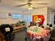 Bright living room featuring a ceiling fan, and is cluttered with furniture and belongings at 5422 Oakway Dr, Lakeland, FL 33805