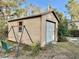 Exterior view of the backyard shed with a swing, offering additional storage at 5422 Oakway Dr, Lakeland, FL 33805