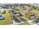 Aerial view of a home with a pond, mature trees, and a well-manicured lawn at 5435 Myrtle Hill W Dr, Lakeland, FL 33811