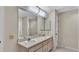 Bright bathroom includes a dual sink vanity with decorative mirrors at 5435 Myrtle Hill W Dr, Lakeland, FL 33811