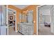 Bathroom with a marble countertop vanity, framed mirror and adjacent doorways leading to a bedroom and storage area at 5435 Myrtle Hill W Dr, Lakeland, FL 33811