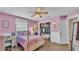 Charming bedroom with pink walls features a surfboard and a closet at 5435 Myrtle Hill W Dr, Lakeland, FL 33811