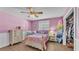 Pretty pink bedroom showcases a four-poster bed, vintage dresser, and white wainscoting at 5435 Myrtle Hill W Dr, Lakeland, FL 33811