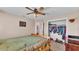 Bedroom featuring hardwood floors, a closet and a ceiling fan at 5435 Myrtle Hill W Dr, Lakeland, FL 33811