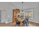 Bright dining area with wooden table, black chairs, and matching wooden hutch at 5435 Myrtle Hill W Dr, Lakeland, FL 33811