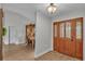 Inviting foyer with wood flooring, elegant double doors and view of the dining area at 5435 Myrtle Hill W Dr, Lakeland, FL 33811