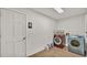 Well-equipped laundry room with wood-look floors, washer, and dryer at 5435 Myrtle Hill W Dr, Lakeland, FL 33811