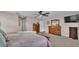 Relaxing main bedroom featuring neutral tones, a dresser, and a view into the bath area at 5435 Myrtle Hill W Dr, Lakeland, FL 33811