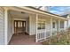 Charming porch featuring double-door entry, brick flooring and decorative trim at 5435 Myrtle Hill W Dr, Lakeland, FL 33811