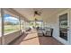 Relaxing screened porch with brick flooring, ceiling fans, and outdoor furniture at 5435 Myrtle Hill W Dr, Lakeland, FL 33811