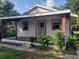 View of the side exterior showcasing the covered porch with red supports at 5515 3Rd Se St, Lakeland, FL 33812