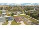 An aerial view of the property in the neighborhood, showing the surrounding landscape, roads and houses nearby at 554 Lorient Dr, Eagle Lake, FL 33839