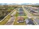 Aerial view of the property with a long driveway, green grass and landscaping with the house in the background at 554 Lorient Dr, Eagle Lake, FL 33839