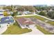 An aerial view of the property with a long driveway, green grass and a beautiful, well-maintained landscape at 554 Lorient Dr, Eagle Lake, FL 33839