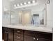 Bathroom features a double sink vanity with dark cabinets and granite counter top at 554 Lorient Dr, Eagle Lake, FL 33839