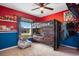 Bright bedroom with a bunk bed, red walls, and a window allowing natural light at 554 Lorient Dr, Eagle Lake, FL 33839