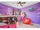 Purple bedroom with a halloween themed bed, a red beanbag chair, and an assortment of decor at 554 Lorient Dr, Eagle Lake, FL 33839