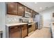 Modern kitchen with granite counters, dark cabinetry, stainless steel appliances and tile backsplash at 554 Lorient Dr, Eagle Lake, FL 33839