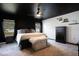 Beautiful main bedroom featuring a dark ceiling, large windows, a king bed, and a dresser at 554 Lorient Dr, Eagle Lake, FL 33839