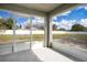 Screened in patio that looks out onto a large yard with a white fence surrounding the property at 554 Lorient Dr, Eagle Lake, FL 33839