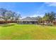 Large backyard features a wood privacy fence, large grassy space, and covered patio at 560 Hatchwood Dr, Haines City, FL 33844