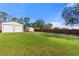 Sprawling backyard features a metal shed, storage building, and a full wood privacy fence at 560 Hatchwood Dr, Haines City, FL 33844