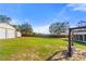 Large backyard with a wood privacy fence, a storage building, and a covered porch swing set at 560 Hatchwood Dr, Haines City, FL 33844