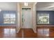 Bright foyer with hardwood floors, white door, and natural light from large windows at 560 Hatchwood Dr, Haines City, FL 33844