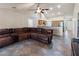 Inviting living room with a leather sectional sofa, a ceiling fan, and tile flooring at 560 Hatchwood Dr, Haines City, FL 33844