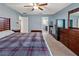 Comfortable bedroom featuring neutral walls, dark wood furniture and ensuite bathroom at 560 Hatchwood Dr, Haines City, FL 33844