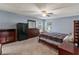 Cozy bedroom with neutral walls, ceiling fan, and dark wood furniture at 560 Hatchwood Dr, Haines City, FL 33844