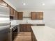 Kitchen area featuring stainless steel appliances, hard surface countertops, island, and wood cabinets at 5751 Freshwater Canyon Dr, St Cloud, FL 34771