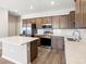 Kitchen showcasing stainless steel appliances, hard surface countertops, island, and wooden cabinets at 5751 Freshwater Canyon Dr, St Cloud, FL 34771