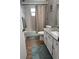 Clean bathroom featuring a shower-tub combination with a striped curtain and a granite-topped vanity at 5982 Crane Dr, Lakeland, FL 33809