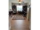 Well-lit home office with two desks, bookcases, and a decorative area rug on the hardwood floor at 5982 Crane Dr, Lakeland, FL 33809